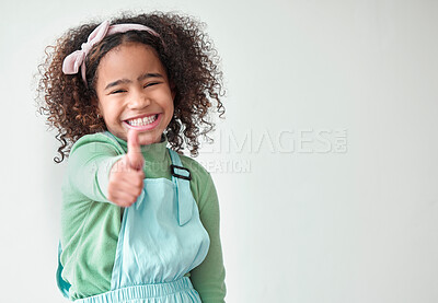 Buy stock photo Thumbs up, kid or portrait on studio space for yes, approval or excited for agreement. Girl, hand gesture or smile on white background for choice, thank you or appreciation with positivity in Brazil