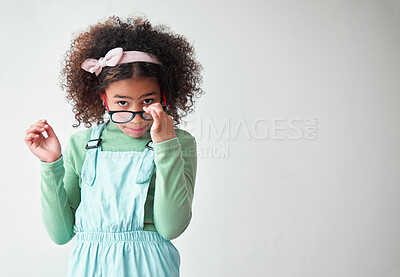 Buy stock photo Child, glasses and portrait in studio with attitude, question and what with space. Young girl, looking and spectacles on white background mockup for opinion, expression and casual fashion in Colombia