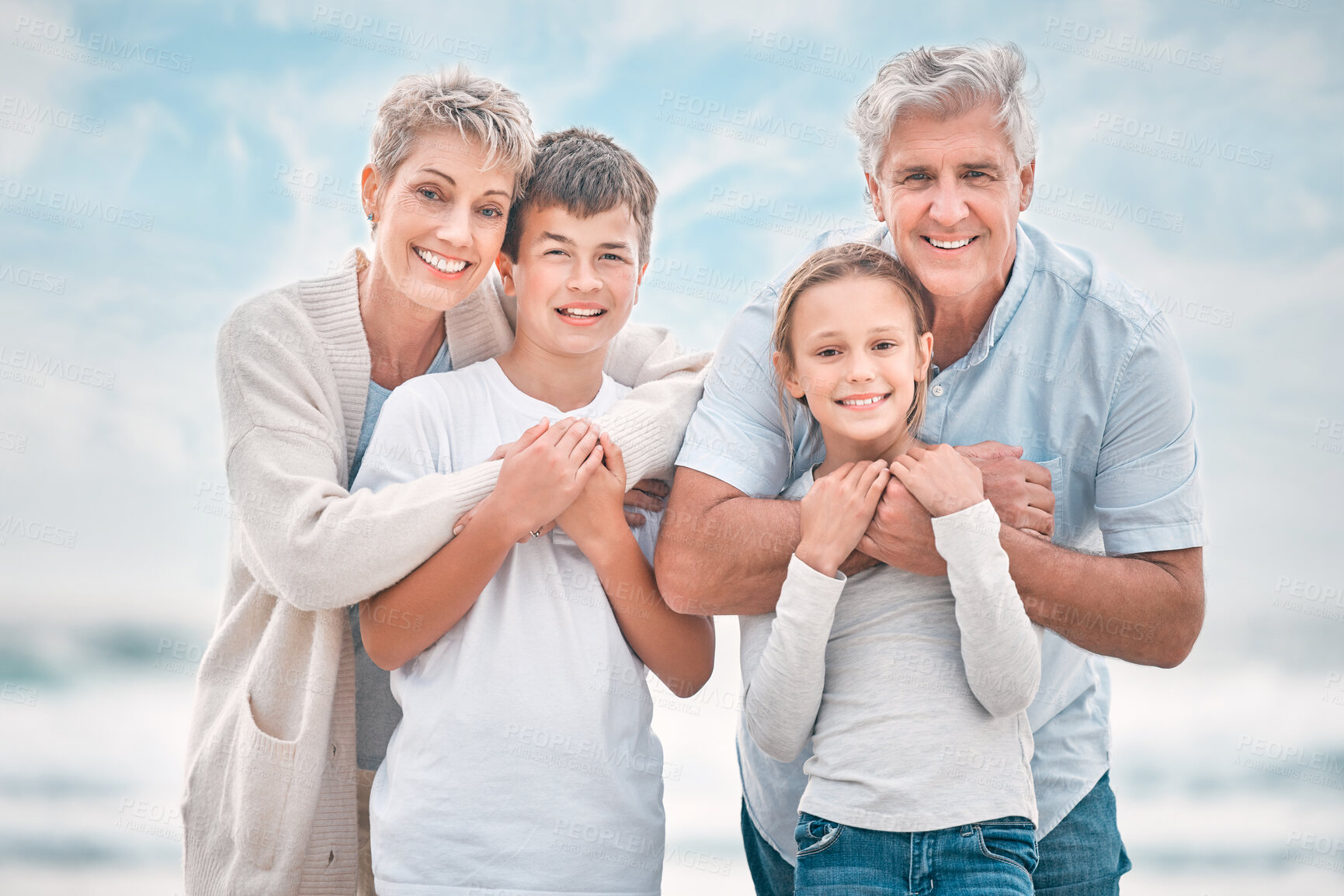 Buy stock photo Portrait, grandparents and grandkids embracing on beach together for holiday, travel or vacation. Hug, love or summer with mature people, brother and sister children outdoor for bonding or wellness