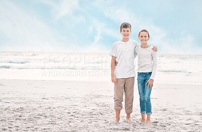 Buy stock photo Shot of a young brother and sister bonding at the beach