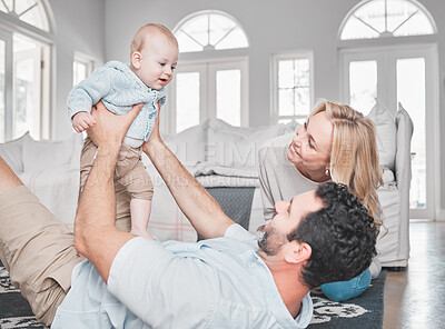 Buy stock photo Relax, living room and parents playing with their baby together on the floor of their family home. Love, smile and happy mother and father bonding with their newborn child in the lounge of a house.