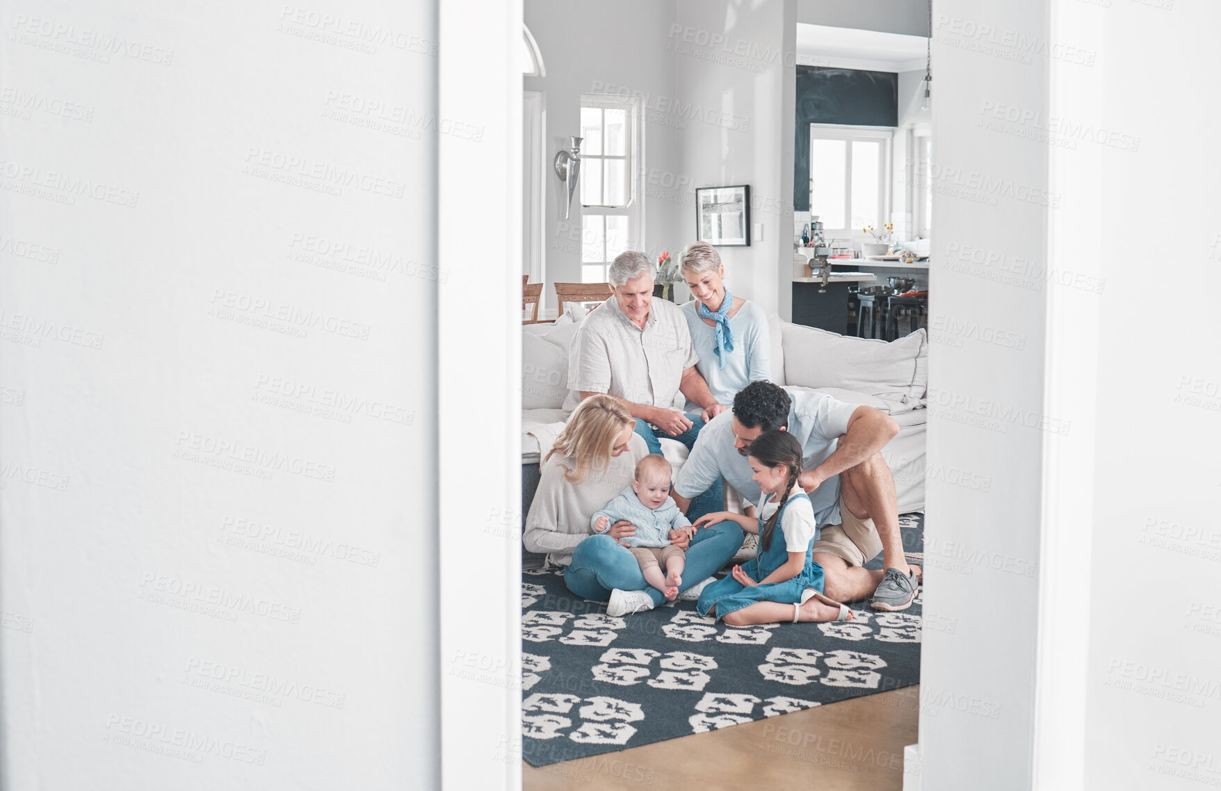 Buy stock photo Big family, relax and children playing in living room, relax and happy in their home together. Content grandparents, parents smile and enjoy fun and kids play on floor while resting on couch in house