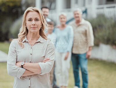 Buy stock photo Shot of a mature woman standing with her arms crossed in the garden at home
