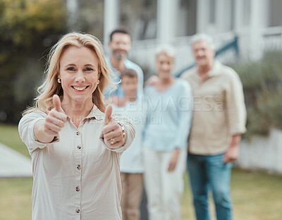 Buy stock photo Shot of a mature woman showing a thumbs up in the garden at home