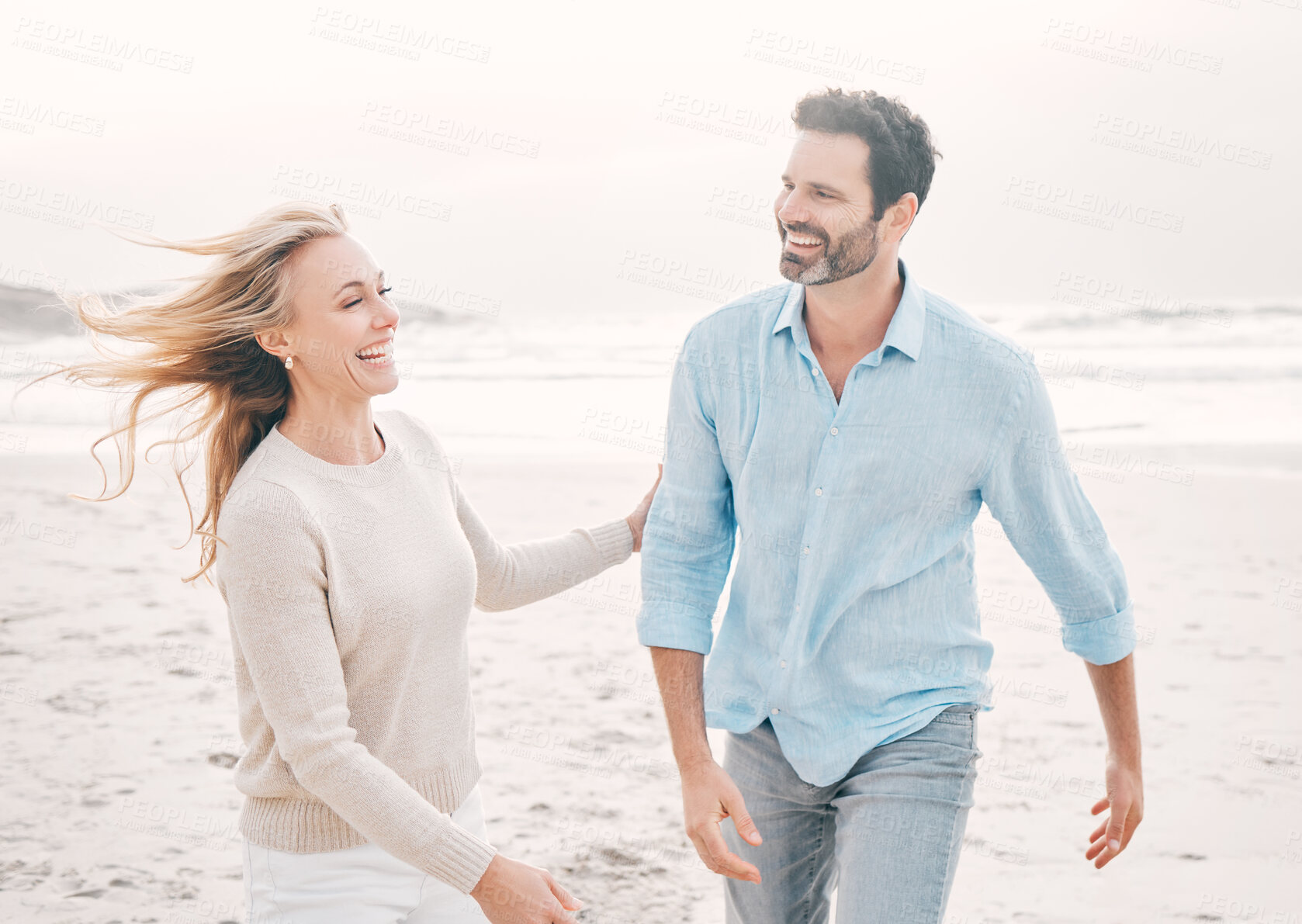 Buy stock photo Love, happy and couple laughing on beach for holiday, vacation and weekend for anniversary. Travel, marriage and happy mature man and woman walking for bonding, quality time and happiness by ocean