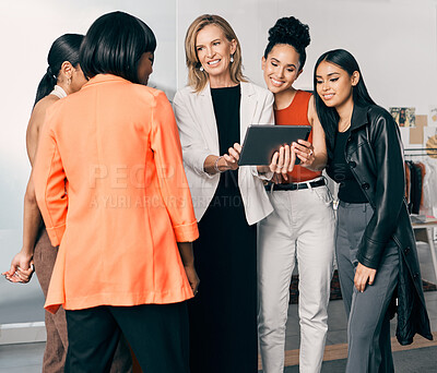 Buy stock photo Shot of a group of businesswomen using a digital tablet together at work