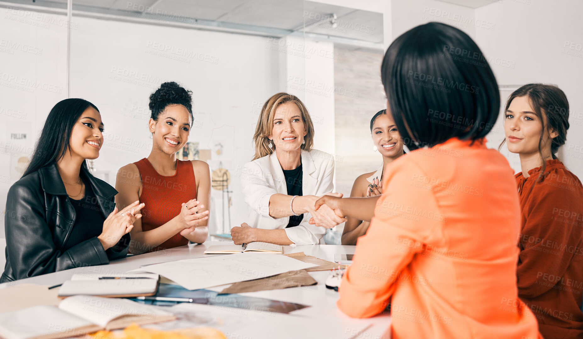 Buy stock photo Shot of two businesswomen shaking hands in a meeting at work