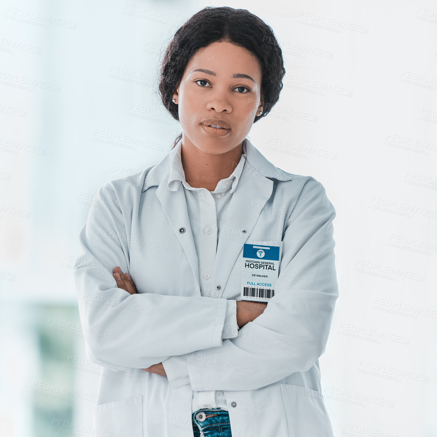 Buy stock photo Portrait of a young doctor standing with her arms crossed in a hospital