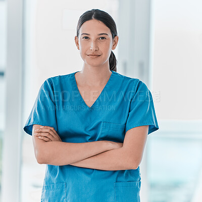Buy stock photo Portrait of a young doctor standing with her arms crossed in a hospital