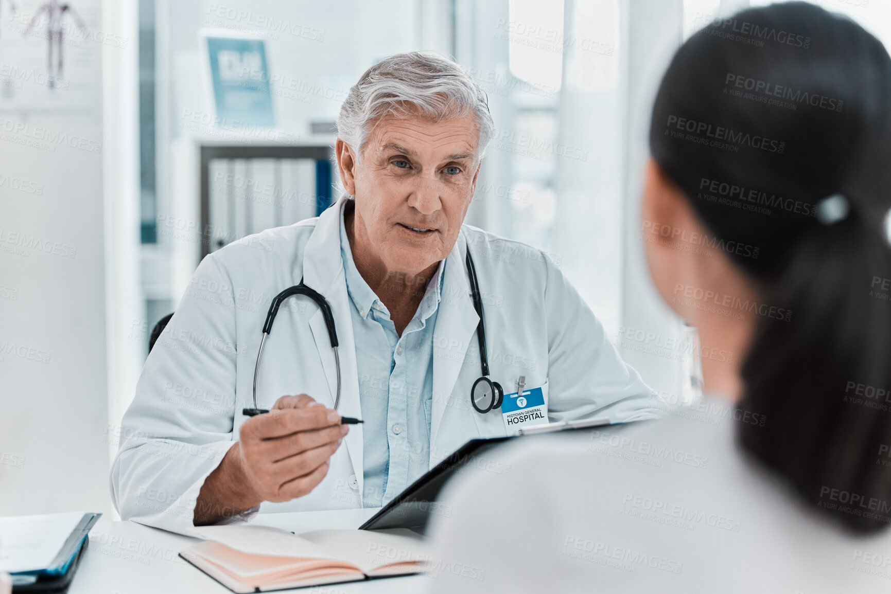 Buy stock photo Mature doctor, patient and appointment in office clinic for healthcare, checkup or advice. Medical professional, woman and conversation for help, exam or results on clipboard in hospital consultation