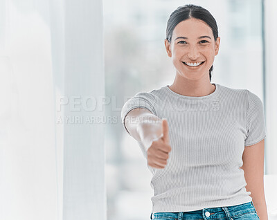 Buy stock photo Shot of an attractive young woman standing alone in the clinic and showing a thumbs up