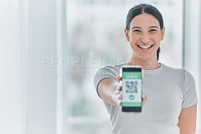 Buy stock photo Shot of an attractive young woman standing alone in the clinic and showing her Covid passport on her cellphone