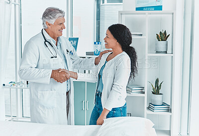 Buy stock photo Shot of a senior doctor shaking hands with a patient in greeting
