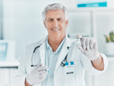 Buy stock photo Shot of a mature doctor holding a vial of the covid vaccine