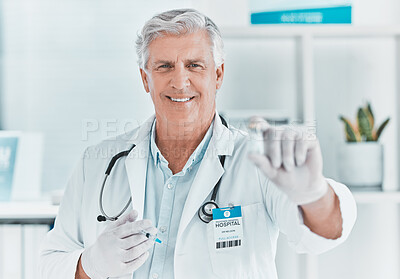 Buy stock photo Shot of a mature doctor holding a vial of the covid vaccine
