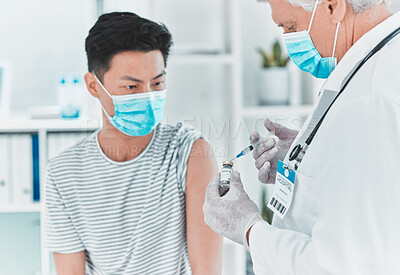 Buy stock photo Shot of a doctor giving his patient an injection