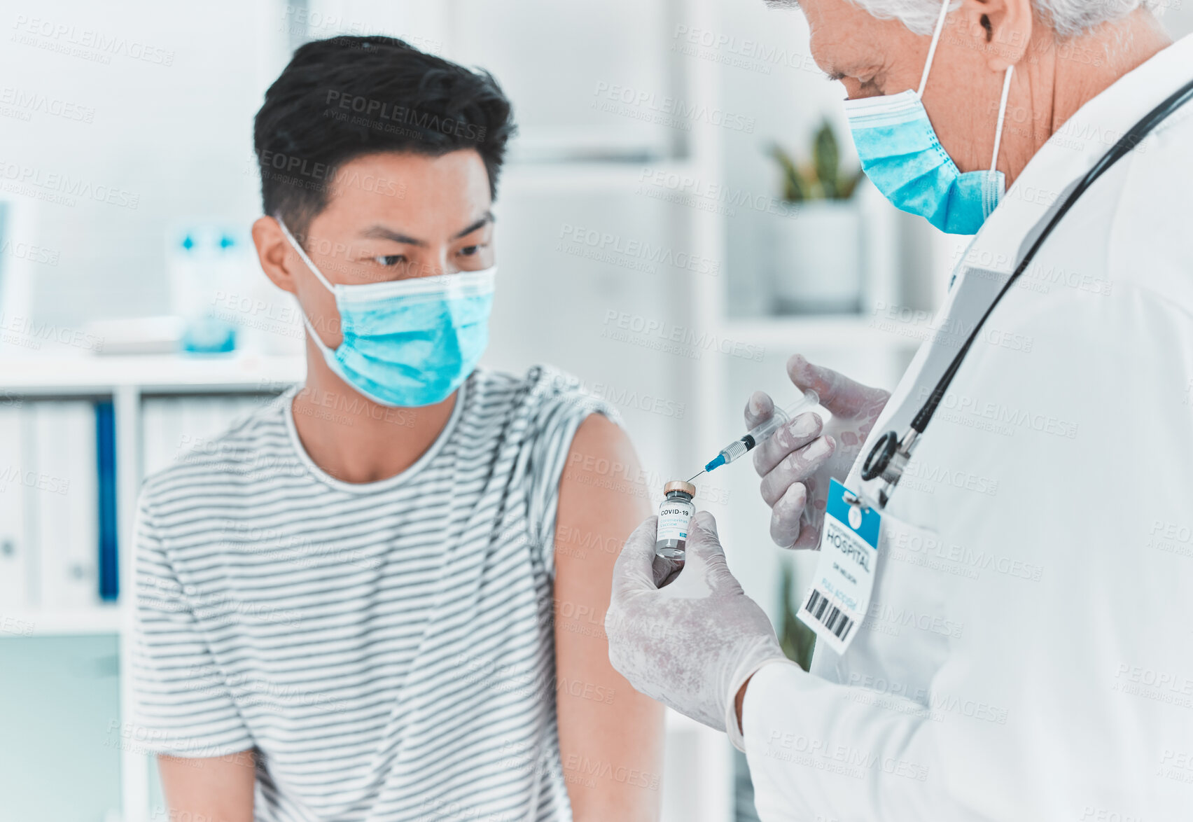 Buy stock photo Shot of a doctor giving his patient an injection