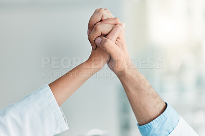 Buy stock photo Closeup shot of two unrecognisable scientists holding their hands together in a lab