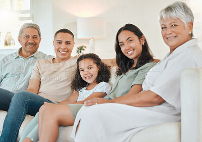 Buy stock photo Shot of a beautiful family bonding on a sofa at home