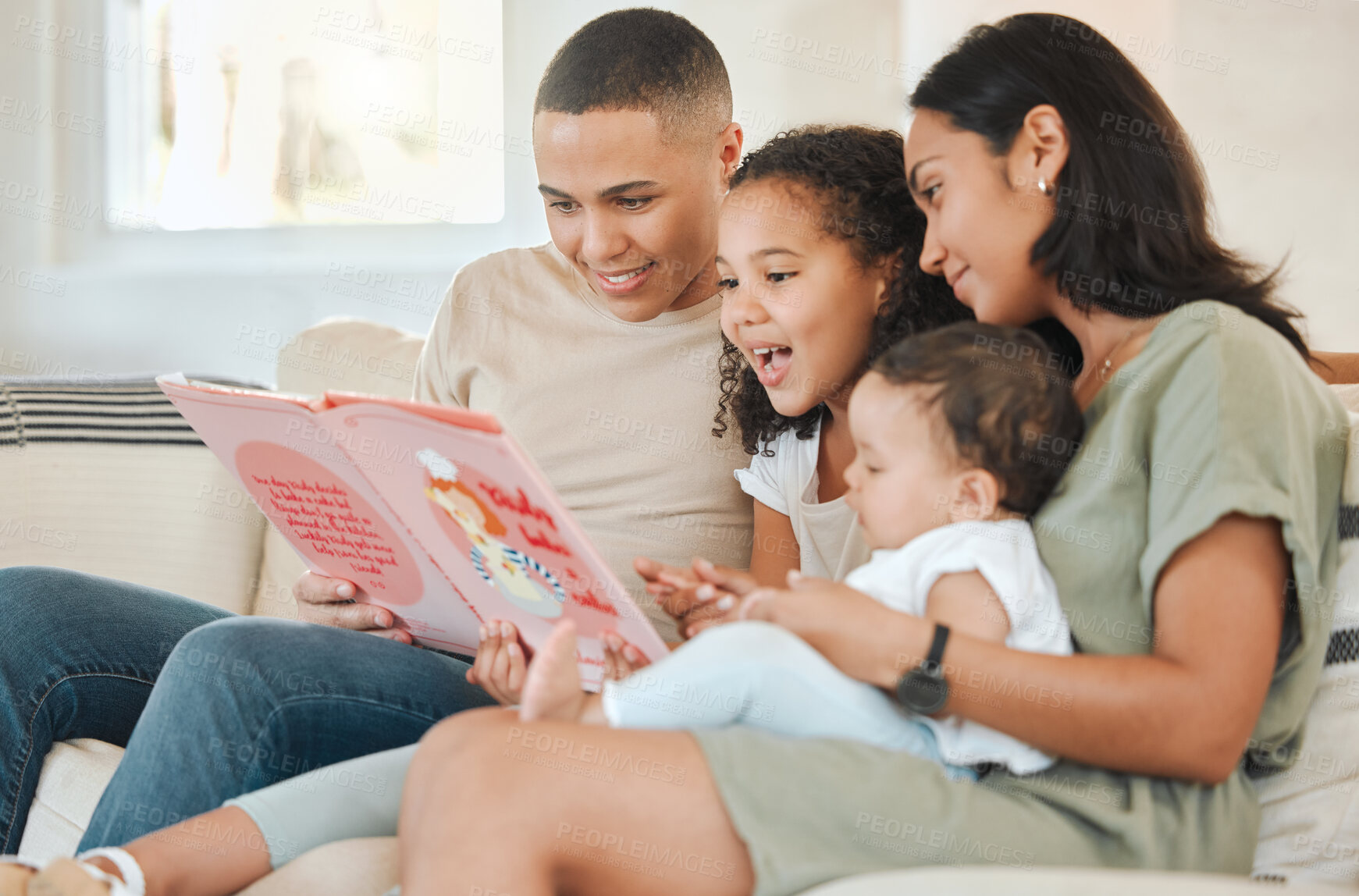Buy stock photo Parents, children and story book on sofa in home with smile, reading and listening for bonding in living room. Father, mother and daughter with baby, happy and connection at family house in Colombia