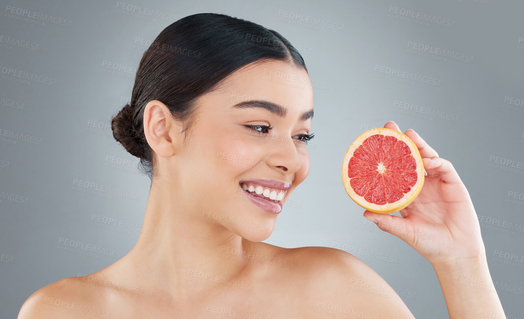 Buy stock photo Woman, smile and fruit for skincare in studio with grapefruit  detox, vitamin c and organic product for healthy skin glow. Beauty, cosmetic and nutritionist for facial treatment on grey background