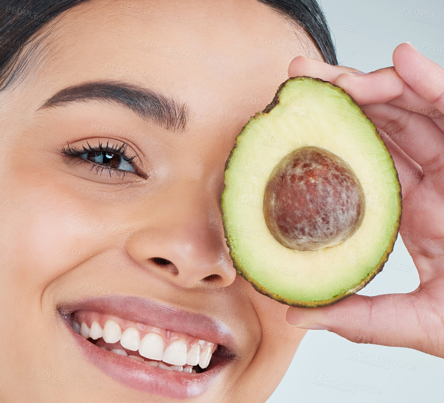 Buy stock photo Skincare, woman and face with avocado in portrait for organic treatment and natural shine in closeup. Beauty, female person and smile with fruit for omega 3 and nutrition with studio background