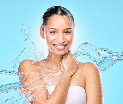 Buy stock photo Water, skincare and shower with portrait of woman in studio for hygiene, beauty and splash. Wellness, cleaning and fresh with face of female model on blue background for spa, cosmetics and liquid