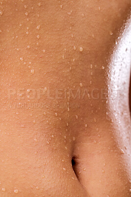 Buy stock photo Studio shot of a woman posing with water droplets on her skin