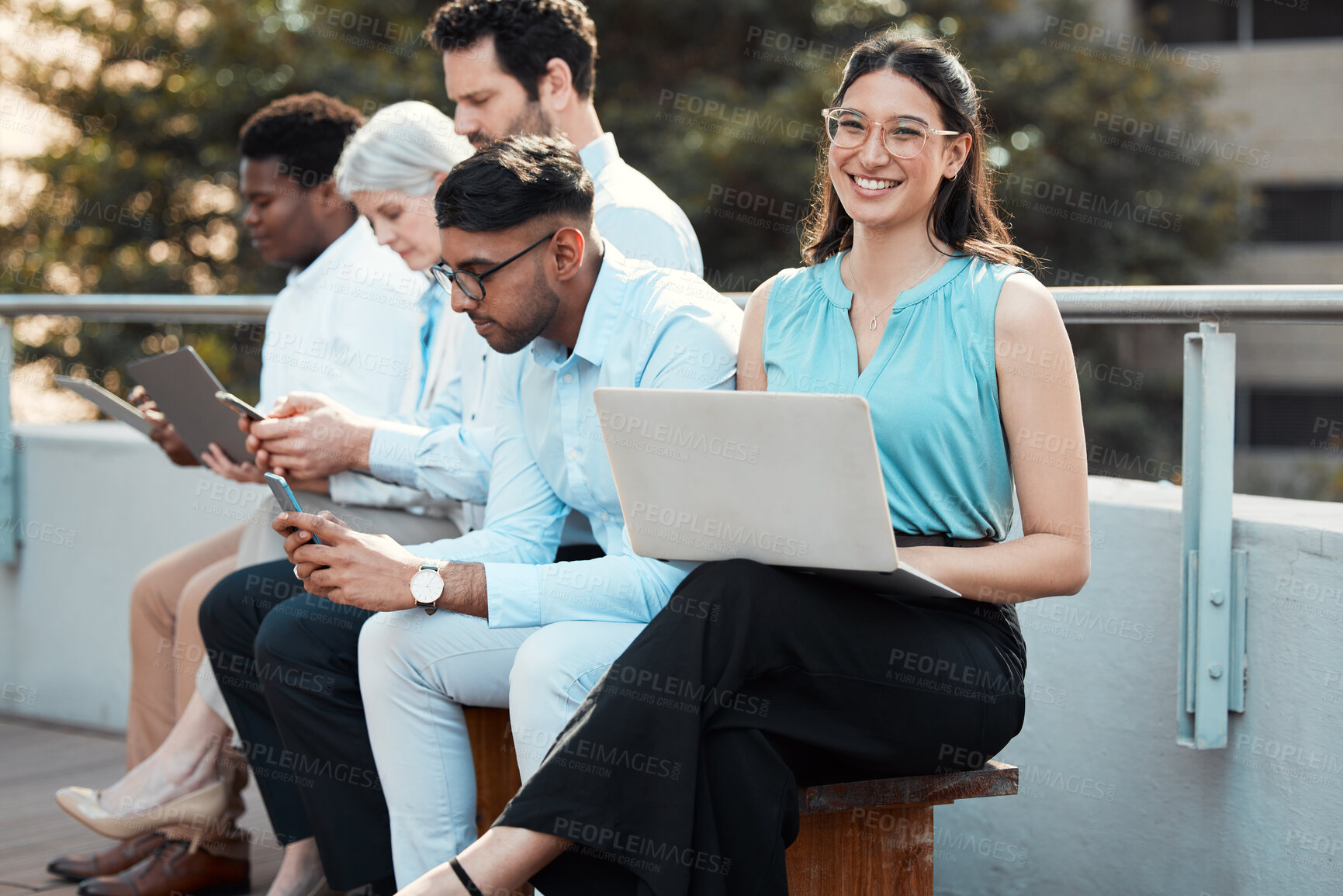 Buy stock photo Business woman, portrait and waiting room with laptop for job opportunity, interview and onboarding. Group of people, tech and diversity for networking, human resources agency and staff on balcony