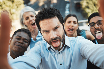 Buy stock photo Shot of a mature businessman standing outside with his colleagues and taking selfies