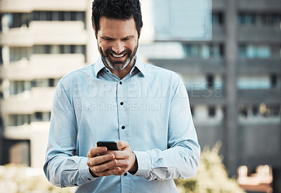 Buy stock photo Shot of a handsome mature businessman standing alone outside and using his cellphone