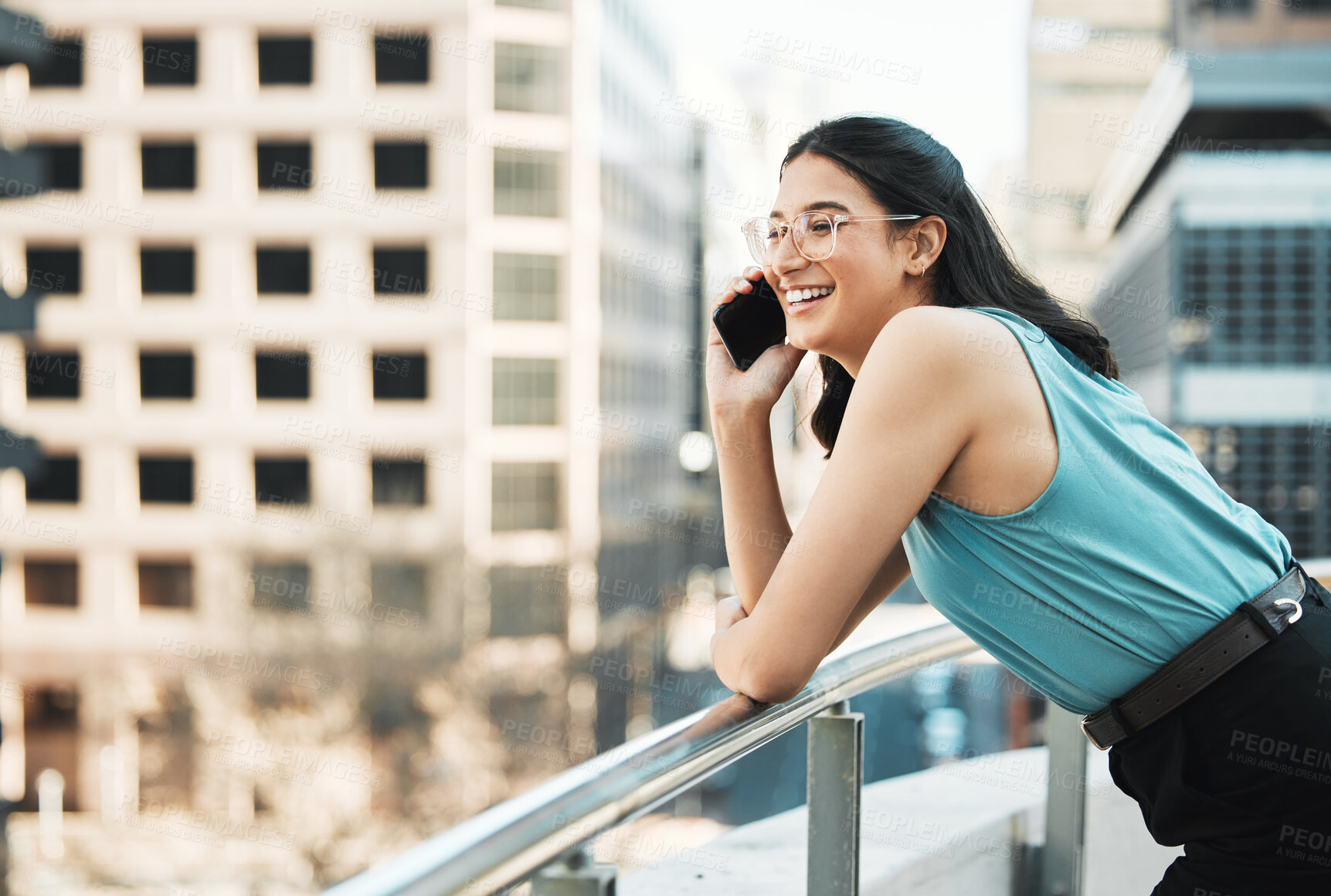 Buy stock photo Shot of an attractive young businesswoman standing alone outside and using her cellphone