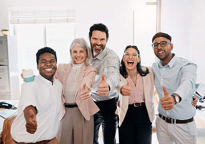 Buy stock photo Shot of a diverse group of businesspeople standing in the office and showing a thumbs up