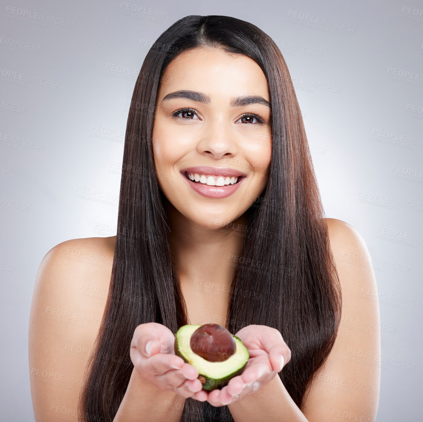 Buy stock photo Girl, portrait and smile with avocado for hair care or organic, natural and omega 3 for treatment or hydration. Woman, fruit and vitamin e for healthy oil or growth, repair and grey background.