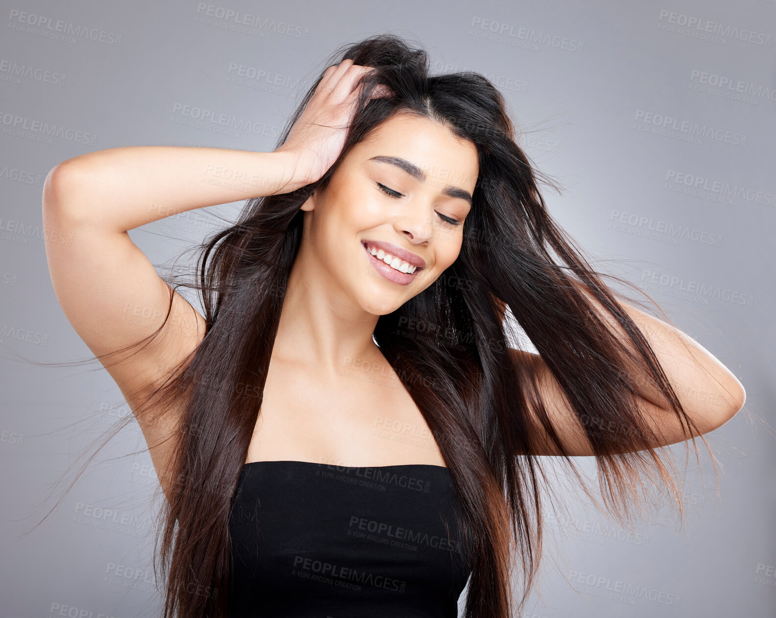 Buy stock photo Woman, hair care and eyes closed in studio with smile, salon and keratin treatment for growth or beauty with natural makeup. Cosmetology, health and skincare with female person, wind and happiness