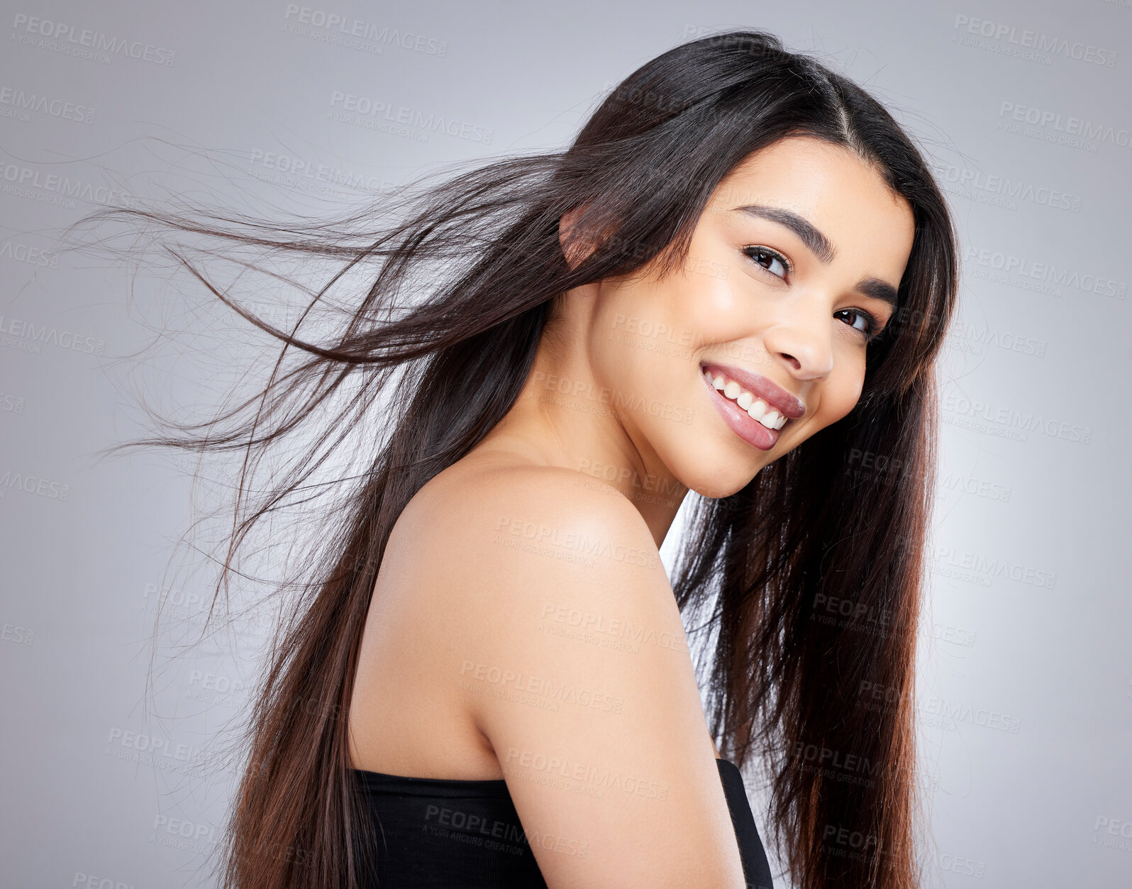 Buy stock photo Woman, smile and portrait in studio for hair care with wind, natural makeup and organic cosmetics for healthy growth. Girl, straight and salon repair on white background, isolated and keratin.