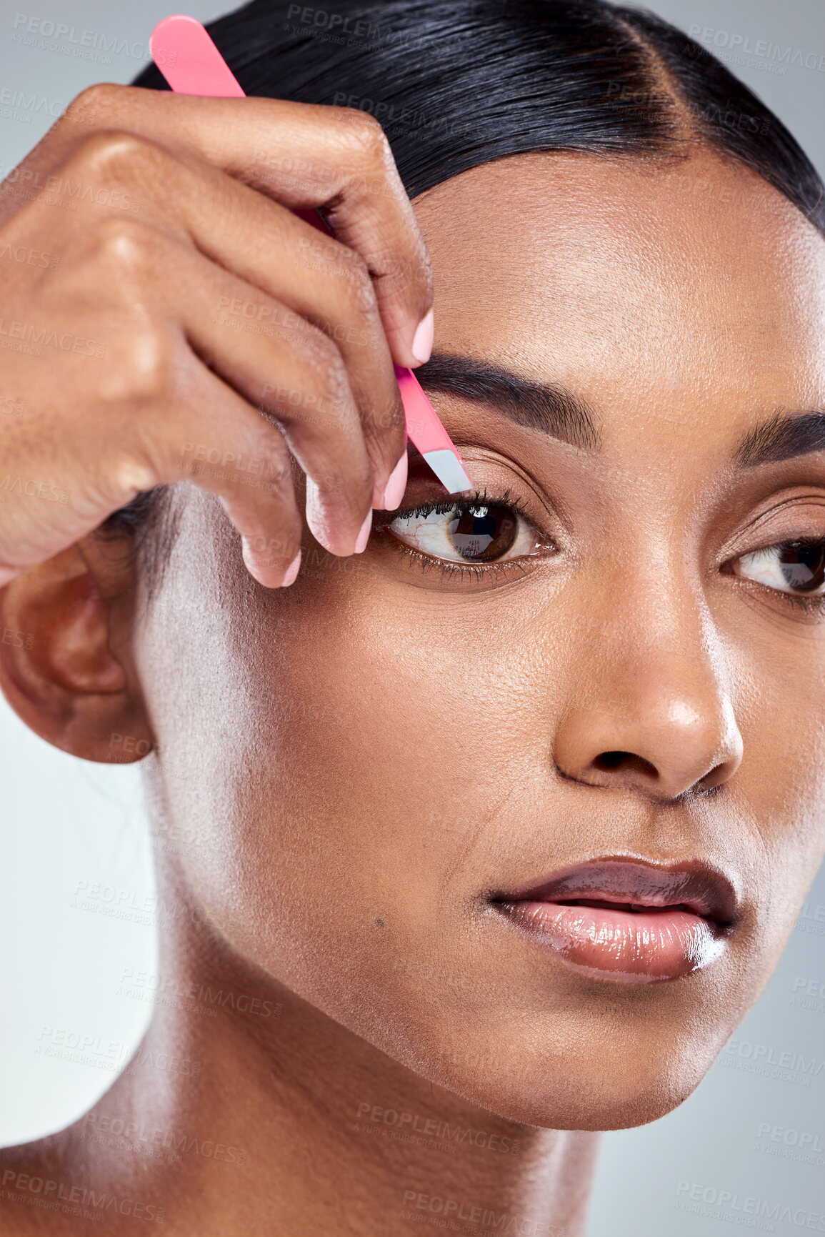 Buy stock photo Face, tweezer and woman in studio for hair removal, correction and skincare on gray background. Indian girl, plucking and hand by eye for self care, beauty and epilation or dermatology with tool