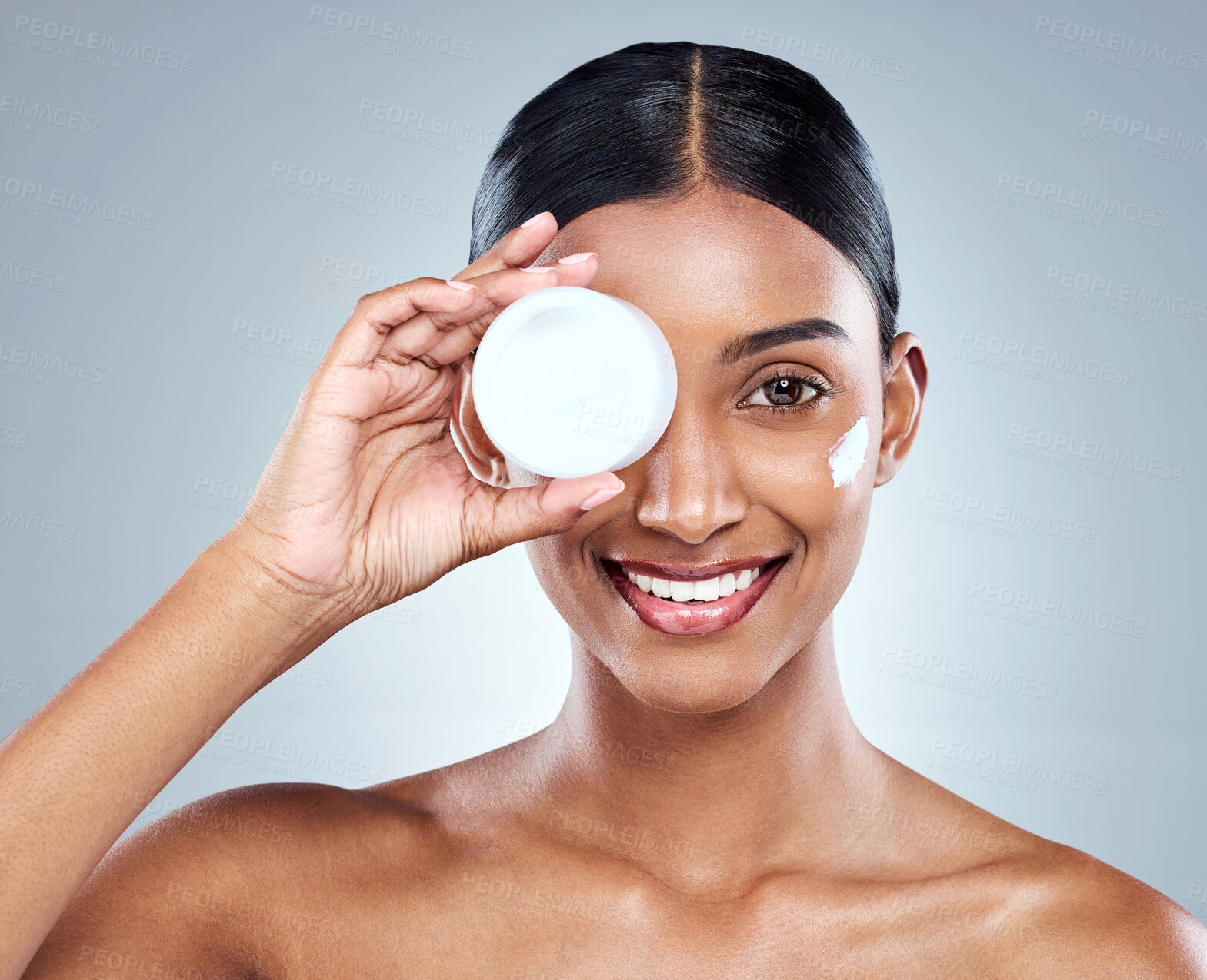 Buy stock photo Product, skincare and Indian woman with hand and cream, beauty or studio on white background. Female person, face and eye with lotion wellness for moisturizing smile or dermatology, health or glow