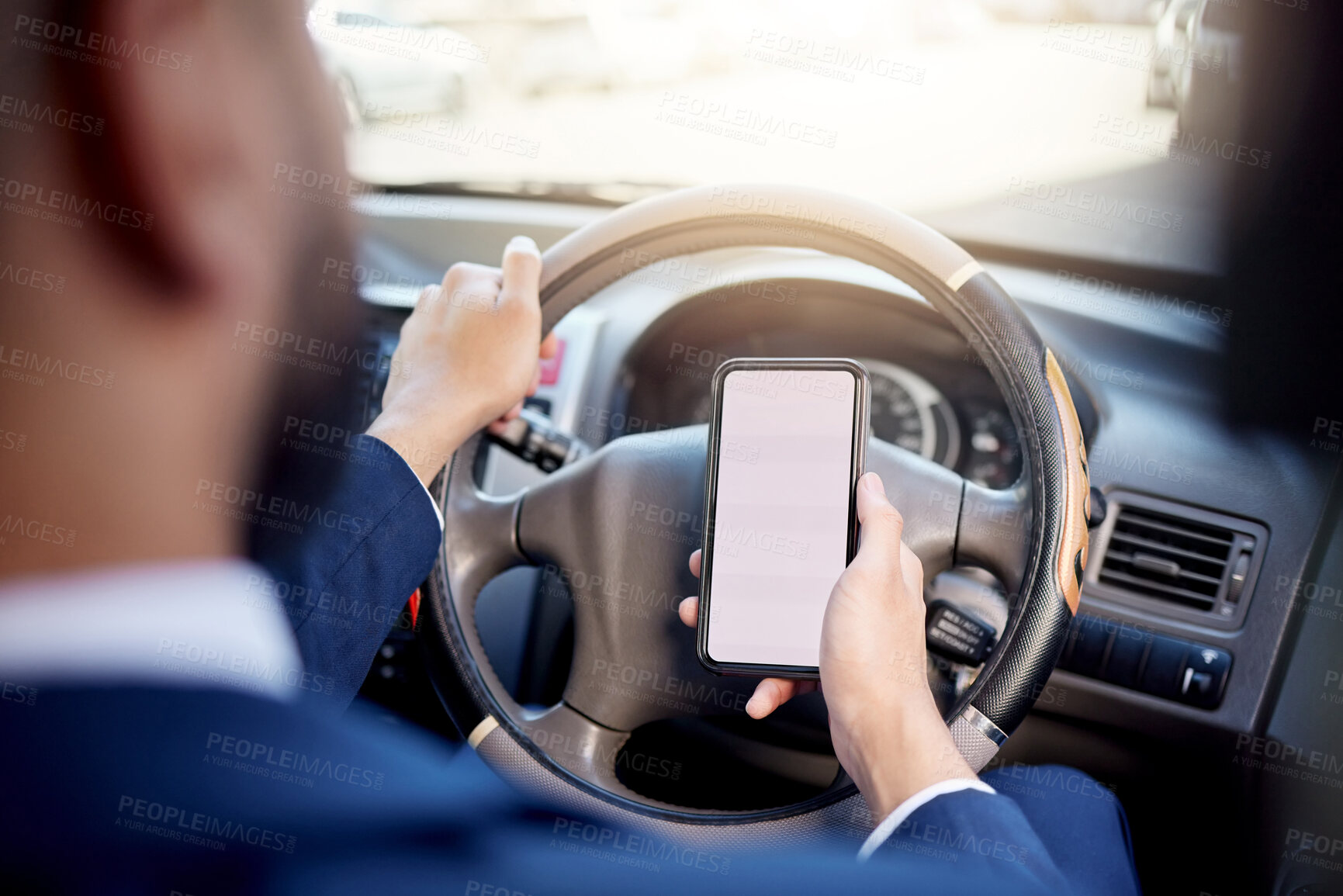 Buy stock photo Closeup shot of an unrecognisable businessman using a cellphone while driving a car