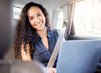 Buy stock photo Portrait of a young businesswoman using a laptop while travelling in a car