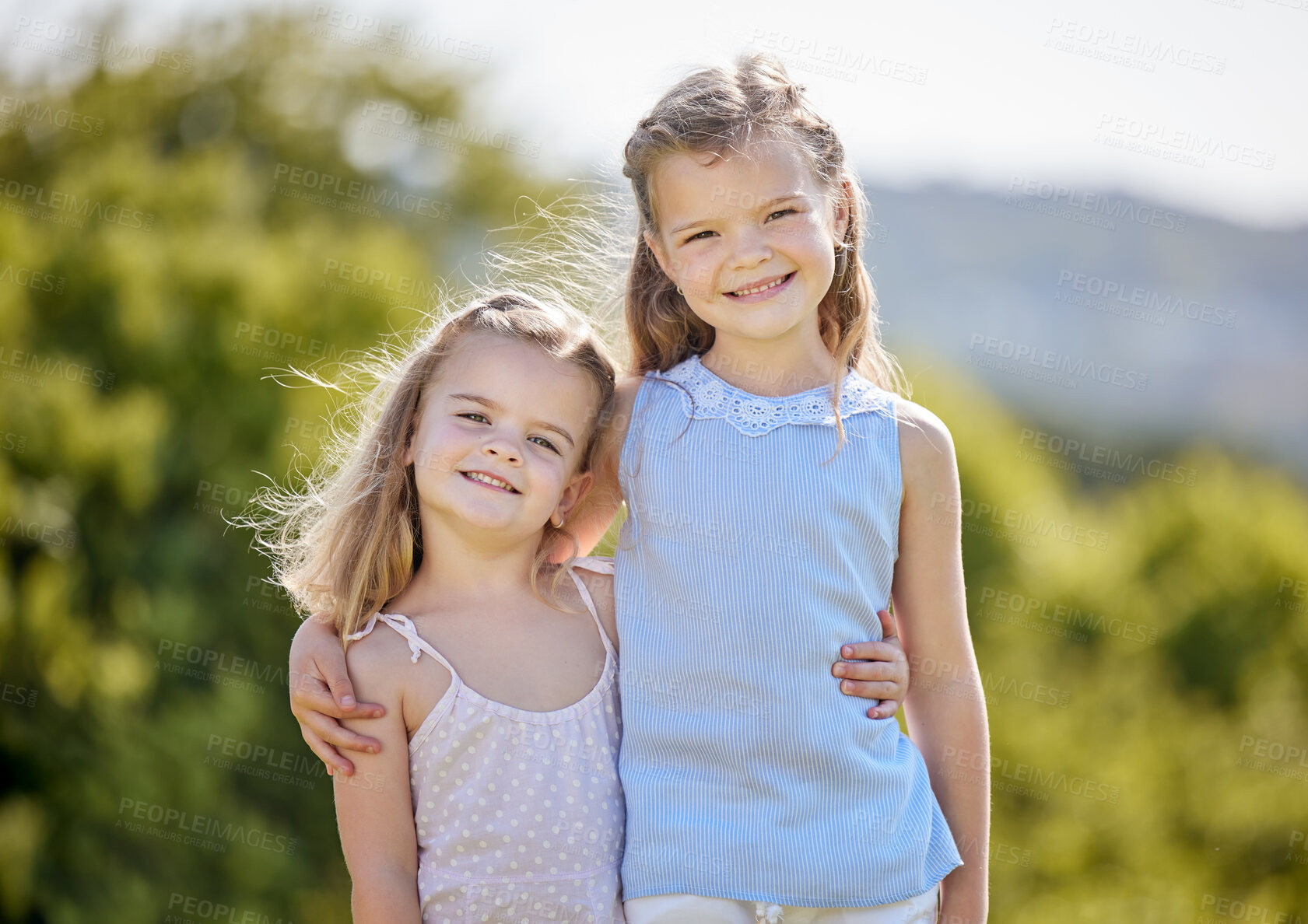 Buy stock photo Shot of two adorable little girls having fun in a park