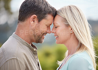 Buy stock photo Shot of an affectionate mature couple standing outside