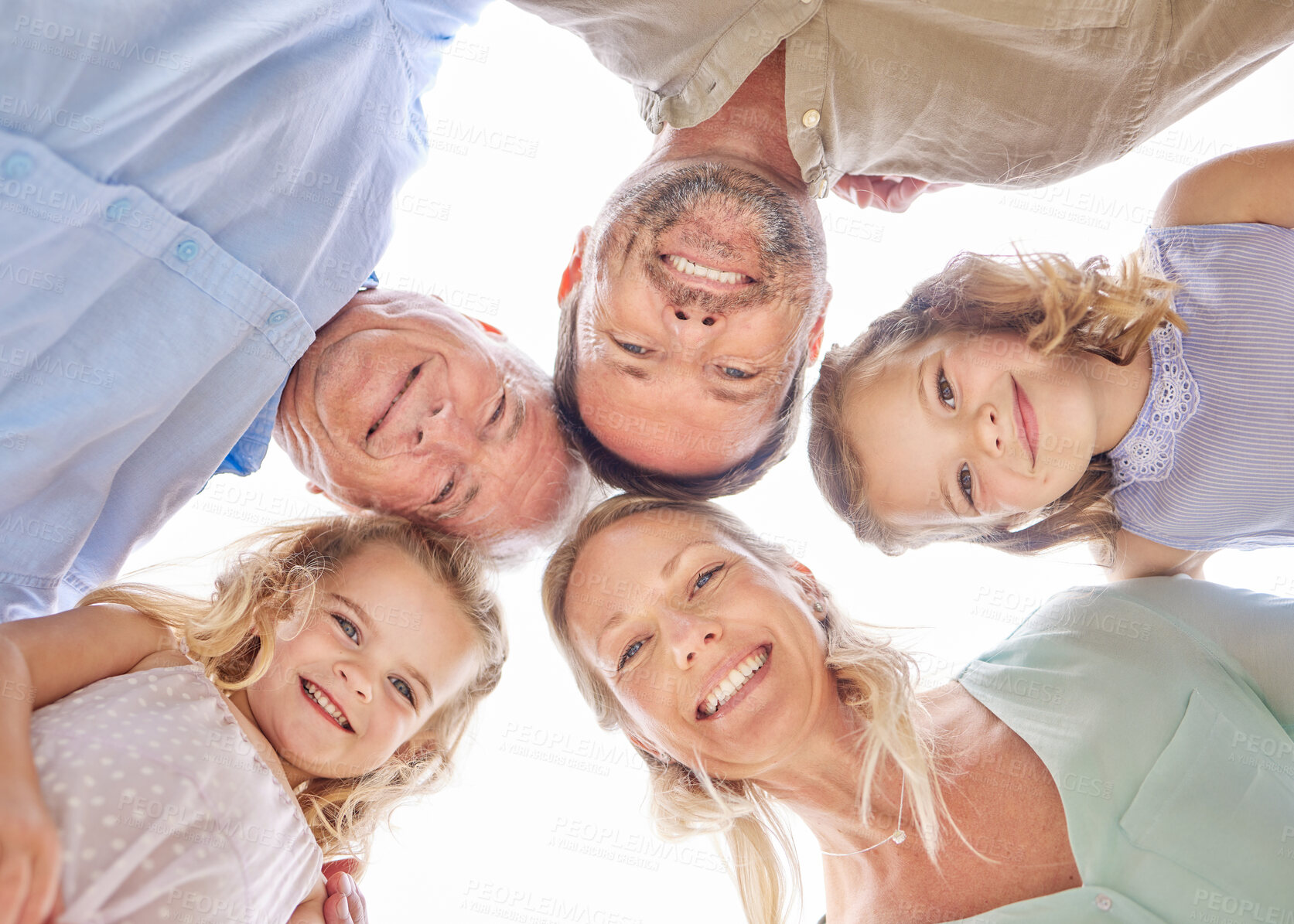 Buy stock photo Portrait, generations and family in circle with kids, smile or outdoor bonding on weekend together. Grandparents, parents and girl children in huddle for love, care or face of happy people from below