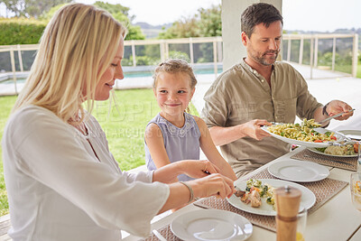 Buy stock photo Shot of a family enjoying sunday lunch together on their patio
