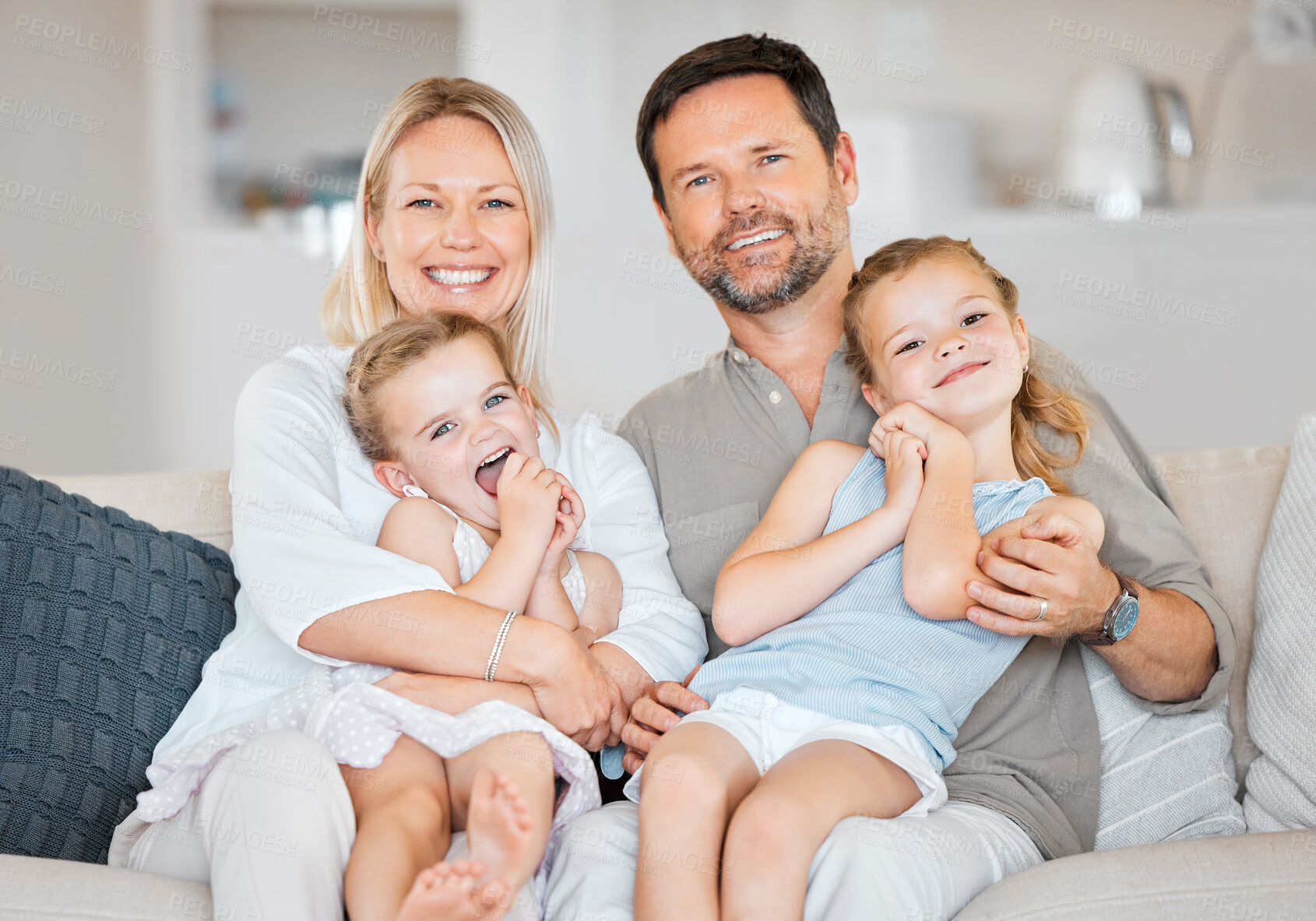 Buy stock photo Parents, portrait and children on sofa for hug, bonding and happy in home with support, care and trust. Family, girl and face on couch in living room for love, relax and smile on weekend with comfort