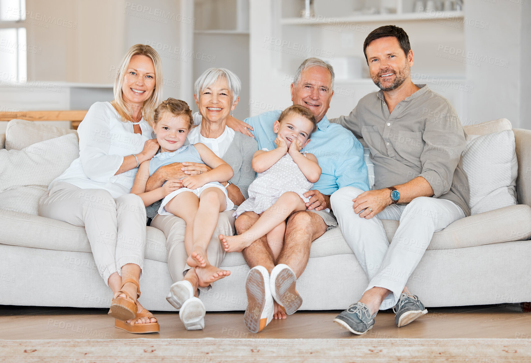 Buy stock photo Big family, happy and portrait on sofa for bonding, hug and relax in home on weekend with love. Grandparents, parents and children together on couch in living room for support, generations or embrace
