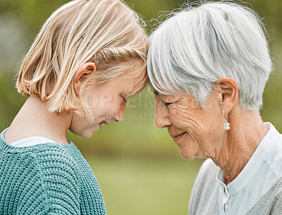 Buy stock photo Shot of an adorable little girl and her grandmother bonding outdoors