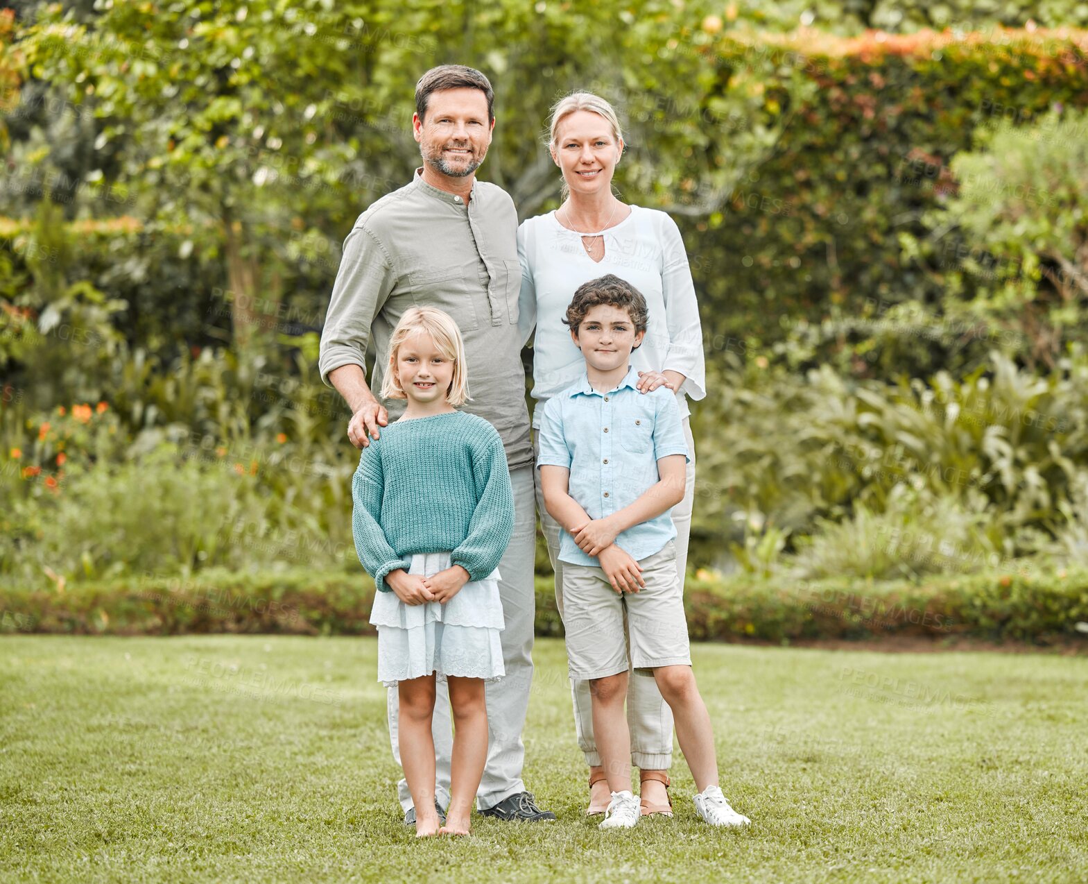 Buy stock photo Happy family, portrait and hug outdoor for bonding, love and embrace on weekend with support at home. Parents, smile and face in backyard for holiday, relax and joy with children, trust and care