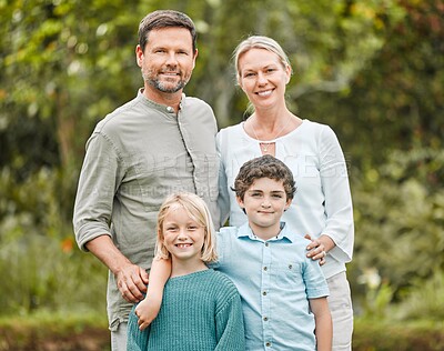 Buy stock photo Shot of a couple standing outside with their two children