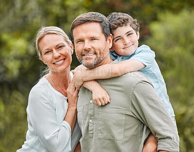 Buy stock photo Shot of a couple and their young son spending time outdoors